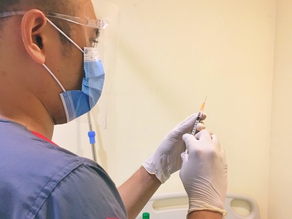 person preparing a vaccine