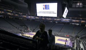 Fans leave the Golden 1 Center after the NBA basketball game between the New Orleans Pelicans and Sacramento Kings was postponed at the last minute in Sacramento, California, Wednesday. The NBA suspended its entire season shortly after. (AP Photo/Rich Pedroncelli)