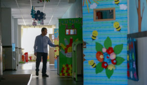 Teacher Egzon Baruti walks through the empty premises of the International School of Prishtina on Thursday, March 19, 2020. (AP Photo/Visar Kryeziu)