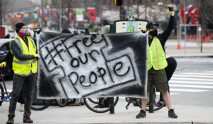 Protesters call for officials to release people from jails, prisons, and immigration detention centers in response to the coronavirus, as they demonstrate outside City Hall in Philadelphia, Monday, March 30, 2020. (AP Photo/Matt Rourke)