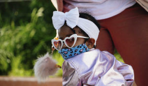 A child wearing a mask and enjoying the weather at Domino Park in Brooklyn during the coronavirus pandemic on May 16, 2020. (John Nacion/STAR MAX/IPx)