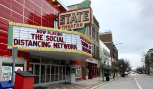 In this March 18, 2020, photo, a tongue-in-cheek message is displayed on the marquee of the State Theatre in Traverse City, Michigan. (AP Photo/John Flesher)