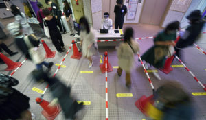 Shoppers maintain social distancing as they walk in line to enter a reopened shopping building Monday, June 1, 2020, in Tokyo. (AP Photo/Eugene Hoshiko)