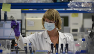 A lab technician works during research on COVID-19, at Johnson & Johnson subsidiary 
in Belgium. (AP Photo/Virginia Mayo)