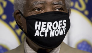 Rep. Danny Davis, D-Ill., wears a mask that reads "Heroes Act Now" as he appears at a news conference on Capitol Hill in Washington, Friday, July 24, on the extension of federal unemployment benefits. (AP Photo/Andrew Harnik)