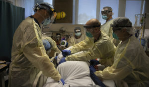 Health care professionals turn a COVID-19 patient over onto his back at St. Jude Medical Center in Fullerton, California. Health care professionals to be among the first to receive a coronavirus vaccine when it is available. (AP Photo/Jae C. Hong)