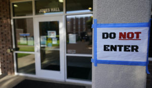 The doorway to Jones Hall is at Utah State University was closed to visitors, Sept. 2, in Logan, Utah, after about 300 students were quarantined to their rooms after coronavirus tests picked up the virus in sewage from the dorm. (AP Photo/Rick Bowmer)