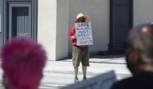 Protesters rally against liability protections for employers relating to COVID-19 on Saturday, Aug. 1, 2020 outside the Legislature in Carson City, Nev. (David Calvert/Nevada Independent via AP, Pool)