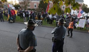 Housing activists gather in front of Gov. Charlie Baker's house, Wednesday, Oct. 14, 2020, in Swampscott, Mass. The protesters were calling on the governor to support more robust protections against evictions and foreclosures during the ongoing coronavirus pandemic. (AP Photo/Michael Dwyer)