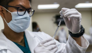 Milan Torres reconstitutes a dose of COVID-19 vaccine, Monday, Dec. 14, 2020, at the Walter Reed National Military Medical Center in Bethesda, Md. (AP Photo/Manuel Balce Ceneta)