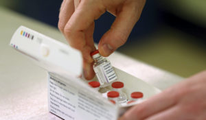 Doses of AstraZeneca's COVID-19 vaccine are checked as they arrive at the Princess Royal Hospital in Haywards Heath, England, Jan. 2. (Gareth Fuller/Pool via AP)