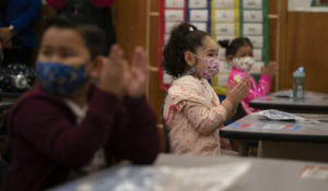 First graders at Heliotrope Avenue Elementary School in Maywood, Calif., applaud while listening to their teacher. (AP Photo/Jae C. Hong, File)