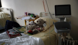 Teddy bears are placed on the bed of a child at the pediatric unit of the Robert Debre hospital, in Paris, France, Wednesday, March 3, 2021. (AP Photo/Christophe Ena)