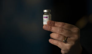 A nurse holds a dose of the AstraZeneca vaccine at the Nestor Kirchner Cultural Center, the largest cultural center in Latin America, where security forces are being vaccinated in Buenos Aires, Tuesday, June 15, 2021. (AP Photo/Victor R. Caivano)