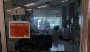 Family members gather outside Daryl Barker's window at Lake Regional Hospital in Osage Beach, Mo., on Monday, July 26, 2021. Daryl was one of 10 family members to become infected with COVID-19 but the 31-year-old's case was by far the worst. None had chosen to be vaccinated, a trend being seen as the delta variant spreads across Missouri's younger population. (AP Photo/Sarah Blake Morgan)