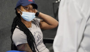 Jniya Tallie speaks with Jackson-Hinds Comprehensive Health Center nurse Maggie Bass after receiving her second dose of the Pfizer vaccine at an open COVID-19 vaccination site at Jackson State University in Jackson, Miss., Tuesday, July 27, 2021. (AP Photo/Rogelio V. Solis)