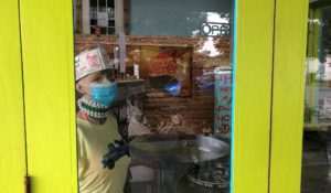 A masked mannequin stands at a table in Cowbell, a New Orleans restaurant, on Friday, Aug. 6, 2021. The restaurant was among the first in New Orleans to require proof of vaccination for indoor dining and masks for outdoor customers. Owner Brack May says some have been angered by the requirement but others welcome it. (AP Photo/Kevin McGill)