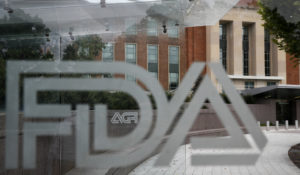 Food and Drug Administration signage is seen through a bus stop at the U.S. Department of Health and Human Services, Thursday, Aug. 2, 2018, in Silver Spring, Md., on the FDA grounds. (AP Photo/Jacquelyn Martin)