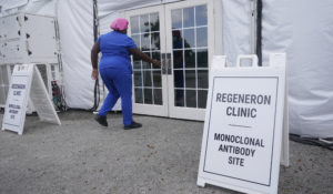 A nurse enters a monoclonal antibody site, Wednesday, Aug. 18, 2021, at C.B. Smith Park in Pembroke Pines. Numerous sites are open around the state offering REGEN-COV to people that tested positive for COVID-19. (AP Photo/Marta Lavandier)