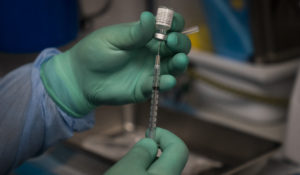 Parsia Jahanbani prepares a syringe with the Pfizer COVID-19 vaccine in a mobile vaccine clinic operated by Families Together of Orange County in Santa Ana, Calif., on Aug. 26, 2021. (AP Photo/Jae C. Hong, File)