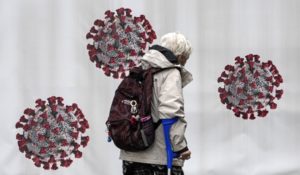 A woman passes a coronavirus test center in Duisburg, Germany, Tuesday, Oct. 12, 2021. Germany ended free rapid coronavirus tests for all last week. Tests remain free only for some groups, like young children and people who can not get vaccinated for medical reasons. (AP Photo/Martin Meissner)