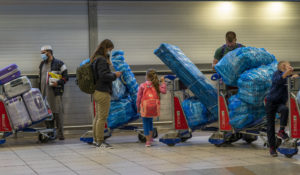 People line up to get on an overseas flight at OR Tambo’s airport in Johannesburg, South Africa, Friday Nov. 26, 2021. (AP Photo/Jerome Delay)