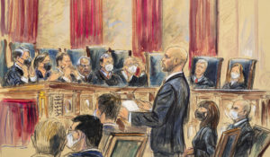 This artist sketch depicts lawyer Scott Keller standing to argue on behalf of more than two dozen business groups seeking an immediate order from the Supreme Court to halt a Biden administration order to impose a vaccine-or-testing requirement on the nation's large employers during the COVID-19 pandemic, at the Supreme Court in Washington, Friday, Jan. 7, 2022. (Dana Verkouteren via AP)