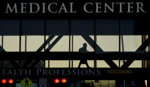 A person walks between buildings at the University of Kansas Hospital Friday, Jan. 28, 2022, in Kansas City, Kan. (AP Photo/Charlie Riedel)