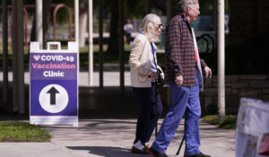 People leave a testing and vaccination clinic for COVID-19 Wednesday, March 30, 2022, in Long Beach, Calif. (AP Photo/Ashley Landis)