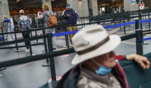 Travelers enter a security line at Rhode Island T.F. Green International Airport in Providence, R.I., Tuesday, April 19, 2022. (AP Photo/David Goldman)