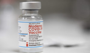 A vial of the Moderna COVID-19 vaccine is displayed on a counter at a pharmacy in Portland, Ore., Monday, Dec. 27, 2021. (AP Photo/Jenny Kane)