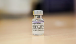 A vial of Pfizer's COVID-19 vaccine ready to be used at Swaminarayan School vaccination centre, in London, Saturday, Dec. 4, 2021. (AP Photo/Alberto Pezzali)