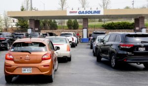 Cars line up for gas outside a Costco Wednesday, May 11, 2022, in Pewaukee, Wis. The Costco offered gas at less than $4 a gallon, some of the cheapest in the area. (AP Photo/Morry Gash)