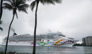 The Norwegian Pearl cruise ship sails to PortMiami, Wednesday, Jan. 5, 2022, in Miami. The ship left on Monday on an 11-day trip to the Panama Canal, but it had to return after several crew and staff tested positive for COVID-19. (AP Photo/Marta Lavandier)