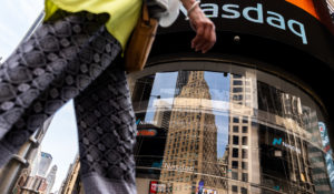 People walk past the Nasdaq MarketSite, Wednesday, July 13, 2022, in New York. (AP Photo/Julia Nikhinson, File)