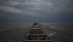 Waves kick up under a dark sky along the shore of Batabano, Cuba, Monday, Sept. 26, 2022. Hurricane Ian was growing stronger as it approached the western tip of Cuba on a track to hit the west coast of Florida as a major hurricane as early as Wednesday. (AP Photo/Ramon Espinosa)