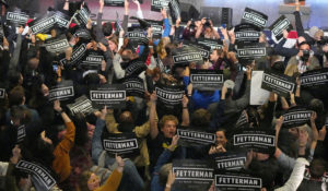 Supporters of Democratic Senate candidate John Fetterman wave signs during an election night party in Pittsburgh on Wednesday. (AP Photo/Gene J. Puskar)