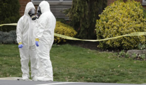 Emergency personnel in protective suits help move people out of St. Joseph's Senior Home in Woodbridge, N.J., Wednesday, March 25, 2020. (AP Photo/Seth Wenig)