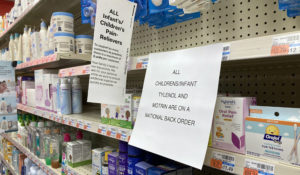 A sign is placed near the section for children's medicine, Sunday, Dec. 18, 2022 at a CVS in Greenlawn, N.Y. Caring for a sick child has become even more stressful than usual for many U.S. parents in recent weeks due to shortages of Children’s Tylenol and other medicines. (AP Photo/Leon Keith)