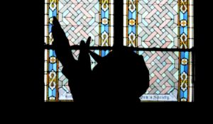 A man prays during a service for Buffalo Bills' player Damar Hamlin on Tuesday at Crossroads Uptown Church in Cincinnati. (AP Photo/Darron Cummings)