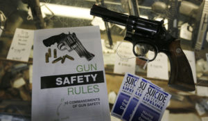 In this Feb. 23, 2016 file photo, gun safety and suicide prevention brochures are on display next to guns for sale at a local retail gun store in Montrose Colo. The Democrat-controlled Colorado Legislature sent a "red flag" bill Monday, April 1, 2019, to the governor that calls for taking firearms from people who police say pose a threat to themselves or others.  (AP Photo/Brennan Linsley, File)