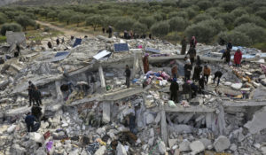 Civil defense workers and residents search through the rubble of collapsed buildings in the town of Harem near the Turkish border, Idlib province, Syria, Monday, Feb. 6, 2023. (AP Photo/Ghaith Alsayed)