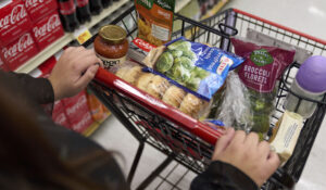 Jaqueline Benitez, who depends on California's SNAP benefits to help pay for food, shops for groceries at a supermarket in Bellflower, Calif., on Monday, Feb. 13, 2023. Nearly 30 million Americans who got extra government help with grocery bills during the pandemic will soon see that aid shrink. (AP Photo/Allison Dinner)