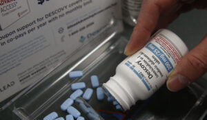 Pharmacist Clint Hopkins displays the HIV prevention drug Descovy, at Pucci's Pharmacy in Sacramento, Calif., Monday, Oct. 7, 2019. (AP Photo/Rich Pedroncelli)