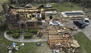 Debris is strewn about a tornado damaged home, Sunday, March 26, 2023, in Rolling Fork, Miss. At least 25 people were killed and dozens of others were injured in Mississippi as the massive storm ripped through several towns late Friday. (AP Photo/Julio Cortez)