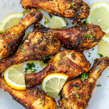 Square image of lemon pepper chicken drumsticks.