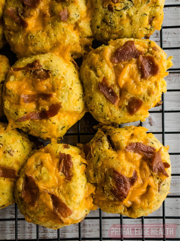 A batch of keto crack biscuits cooling on a wire rack.