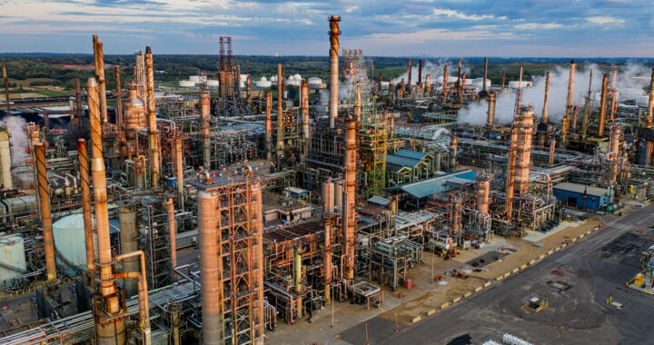 An aerial shot of an oil refinery complex in the U.S. for the article "Explainer: Why Trump Pulled Out the U.S. From the Paris Climate Agreement"