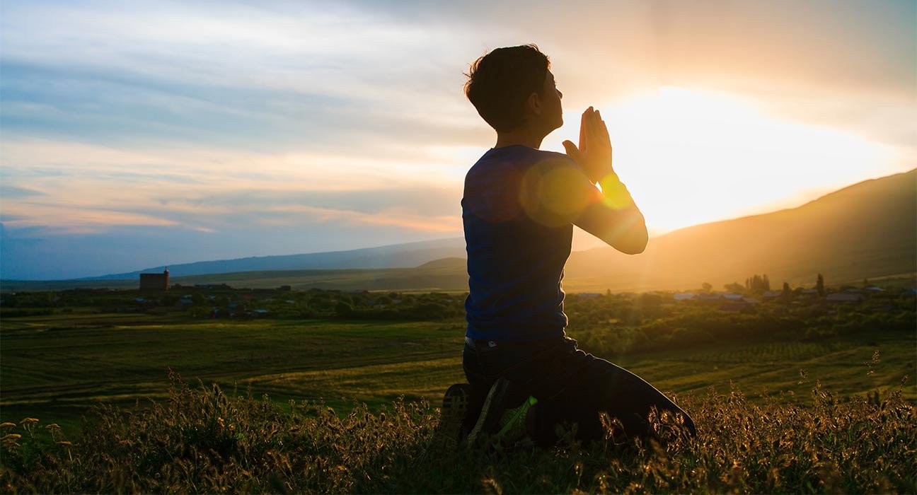 A person sitting in front of the sun