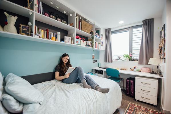 Student relaxing in accommodation room